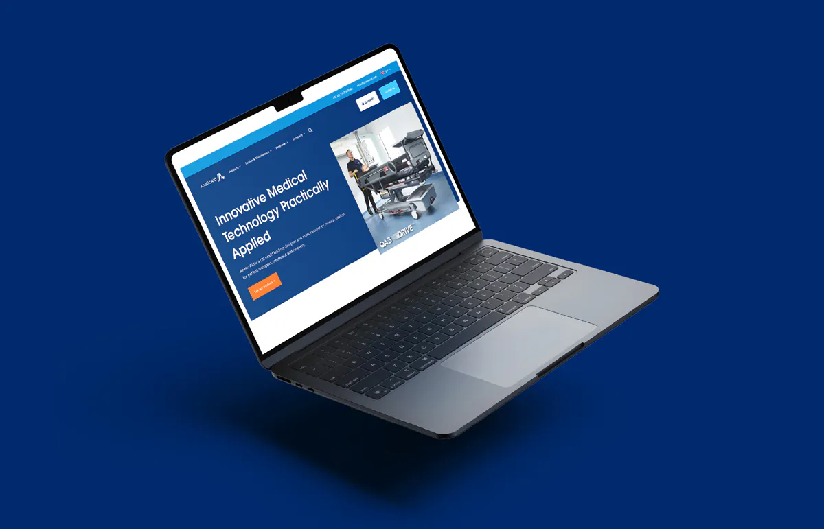 Laptop mockup of the Anetic Aid website homepage.