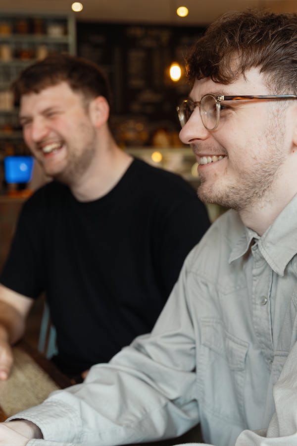 Two men laughing and smiling