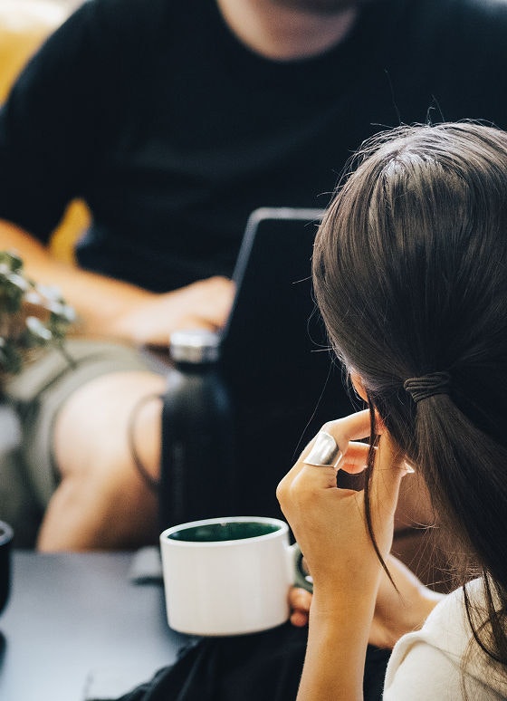 Photo of Mary drinking a coffee