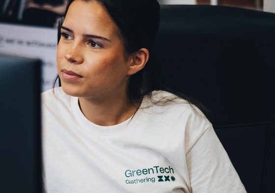 Photo of Mary wearing a GreenTech Gathering t-shirt