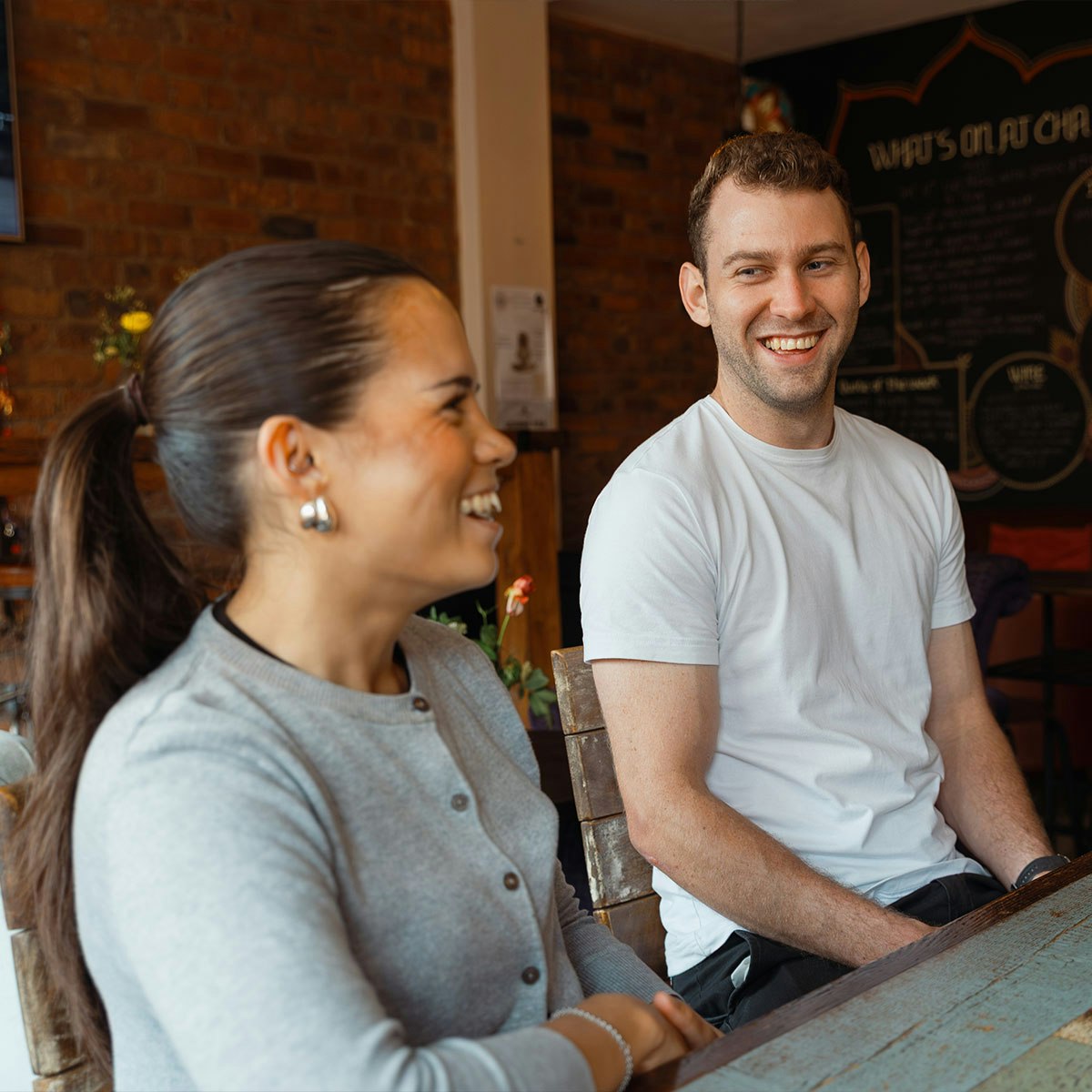 Male and female chatting over coffee