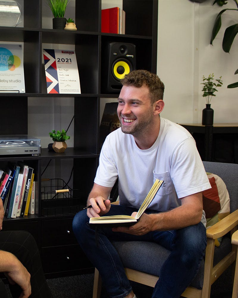 Man smiling with notebook