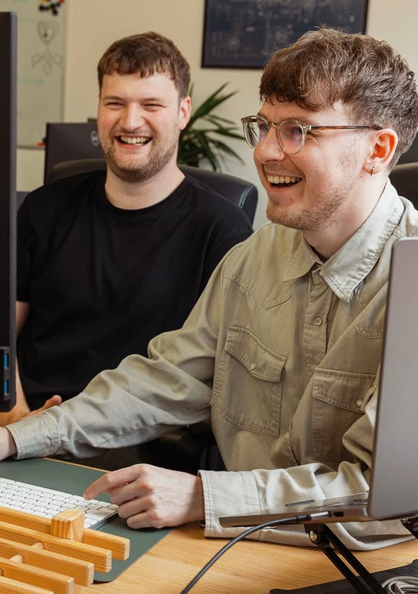 Photograph of Sam & Liam working together.