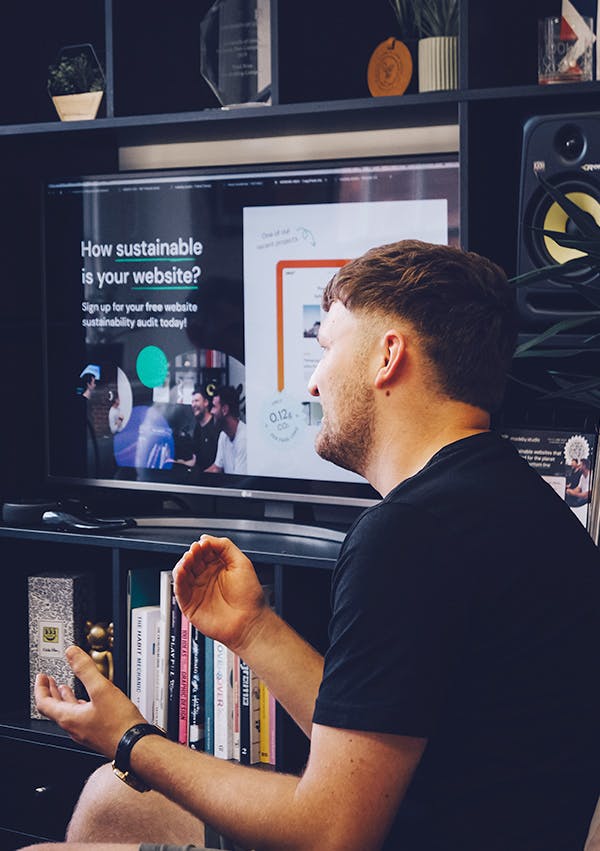 Photograph of Sam in the office presenting.