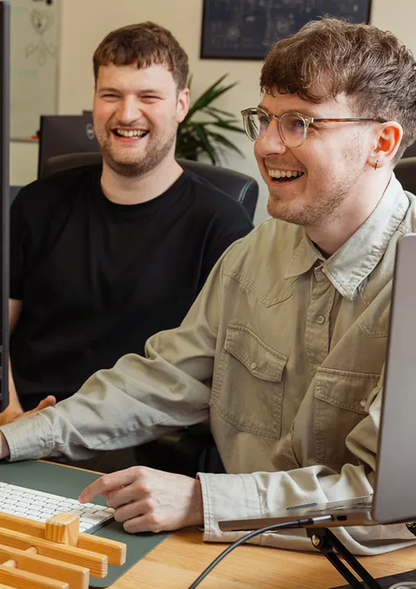 Photograph of Sam & Liam working together.