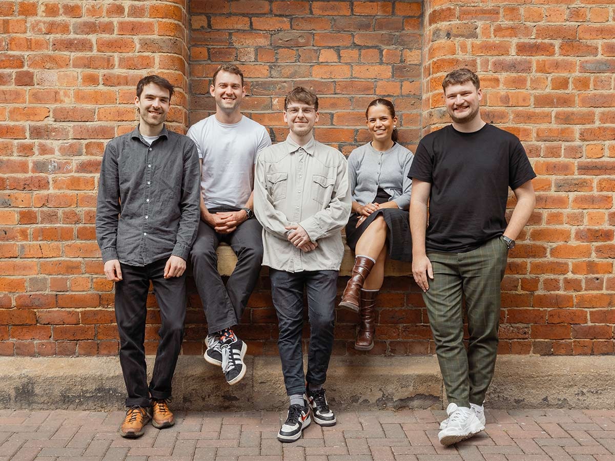 Photo of madeby.studio team in front of a wall